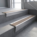 Mill Aluminium raked back aluminium stair nosing 62x55mm with Fawn Castellated infill, fitted to a concrete step