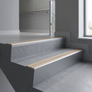 Mill Aluminium raked back aluminium stair nosing 62x55mm with Light Bronze Aluminium infill, fitted to a concrete step