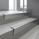 Mill Aluminium raked back aluminium stair nosing 62x55mm with Light Grey Smooth Textured infill, fitted to a concrete step