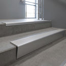 Mill Aluminium raked back aluminium stair nosing 62x55mm with Polar Grey Castellated infill, fitted to a concrete step