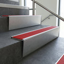 Mill Aluminium raked back aluminium stair nosing 62x55mm with Poppy Castellated infill, fitted to a concrete step