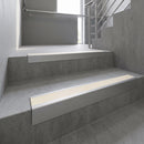 Mill Aluminium raked back aluminium stair nosing 62x55mm with Porth Stone Smooth Textured infill, fitted to a concrete step