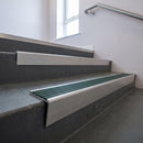Mill Aluminium raked back aluminium stair nosing 62x55mm with Spruce Castellated infill, fitted to a concrete step