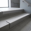 Mill Aluminium raked back aluminium stair nosing 62x55mm with White Castellated infill, fitted to a concrete step