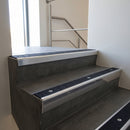 Polished Aluminium raked back aluminium stair nosing 62x55mm with Black Olympic Grip infill, fitted to a concrete step