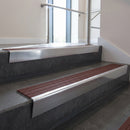 Polished Aluminium raked back aluminium stair nosing 62x55mm with Claret Castellated infill, fitted to a concrete step