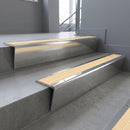 Polished Aluminium raked back aluminium stair nosing 62x55mm with Ivory Castellated infill, fitted to a concrete step