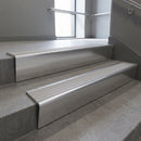 Polished Aluminium raked back aluminium stair nosing 62x55mm with Light Grey Castellated infill, fitted to a concrete step
