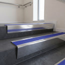 Polished Aluminium raked back aluminium stair nosing 62x55mm with Mid Blue Castellated infill, fitted to a concrete step