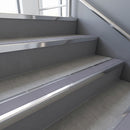 Polished Aluminium raked back aluminium stair nosing 62x55mm with Nimbus Castellated infill, fitted to a concrete step