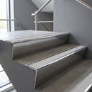 Polished Aluminium raked back aluminium stair nosing 62x55mm with Polar Grey Castellated infill, fitted to a concrete step