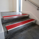 Polished Aluminium raked back aluminium stair nosing 62x55mm with Poppy Castellated infill, fitted to a concrete step