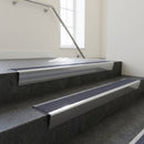 Polished Aluminium raked back aluminium stair nosing 62x55mm with Regency Castellated infill, fitted to a concrete step