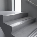 Polished Aluminium raked back aluminium stair nosing 62x55mm with Satin Aluminium infill, fitted to a concrete step