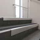 Satin Aluminium raked back aluminium stair nosing 62x55mm with Black Olympic Grip infill, fitted to a concrete step