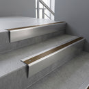 Satin Aluminium raked back aluminium stair nosing 62x55mm with Bronze Aluminium infill, fitted to a concrete step