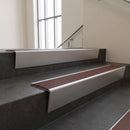 Satin Aluminium raked back aluminium stair nosing 62x55mm with Claret Castellated infill, fitted to a concrete step