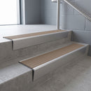 Satin Aluminium raked back aluminium stair nosing 62x55mm with Fawn Castellated infill, fitted to a concrete step
