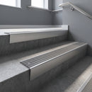 Satin Aluminium raked back aluminium stair nosing 62x55mm with Flint Castellated infill, fitted to a concrete step