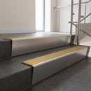 Satin Aluminium raked back aluminium stair nosing 62x55mm with Gold Castellated infill, fitted to a concrete step