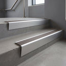 Satin Aluminium raked back aluminium stair nosing 62x55mm with Granite Castellated infill, fitted to a concrete step
