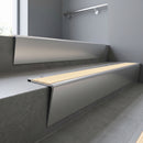 Satin Aluminium raked back aluminium stair nosing 62x55mm with Ivory Castellated infill, fitted to a concrete step