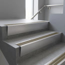 Satin Aluminium raked back aluminium stair nosing 62x55mm with Light Bronze Aluminium infill, fitted to a concrete step
