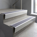 Satin Aluminium raked back aluminium stair nosing 62x55mm with Nimbus Castellated infill, fitted to a concrete step