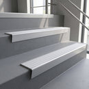Satin Aluminium raked back aluminium stair nosing 62x55mm with Polar Grey Castellated infill, fitted to a concrete step