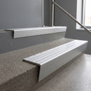 Satin Aluminium raked back aluminium stair nosing 62x55mm with Polished Aluminium infill, fitted to a concrete step