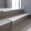 Satin Aluminium raked back aluminium stair nosing 62x55mm with Porth Stone Castellated infill, fitted to a concrete step
