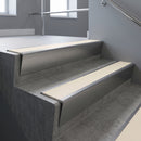 Satin Aluminium raked back aluminium stair nosing 62x55mm with Porth Stone Smooth Textured infill, fitted to a concrete step
