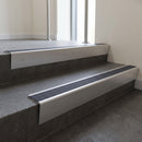 Satin Aluminium raked back aluminium stair nosing 62x55mm with Regency Castellated infill, fitted to a concrete step