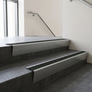 Satin Aluminium raked back aluminium stair nosing 62x55mm with Spruce Castellated infill, fitted to a concrete step
