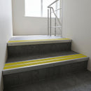 Satin Aluminium raked double channel aluminium stair nosing 90x32mm with Yellow Castellated infill, fitted to a concrete step