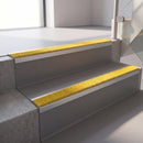 Square edge with ramped back aluminium stair nosing, 70mm tread, brimstone (safety yellow) exterior grip insert, mill finish finish