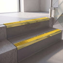 Square edge with ramped back aluminium stair nosing, 70mm tread, brimstone (safety yellow) exterior grip insert, mirrorflect gold finish