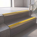 Square edge with ramped back aluminium stair nosing, 70mm tread, brimstone (safety yellow) exterior grip insert, satin gold finish