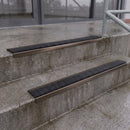 Square edge with ramped back aluminium stair nosing with black gritted exterior grip insert in dark bronze finish fitted on covered external concrete steps