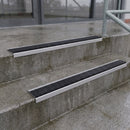 Square edge with ramped back aluminium stair nosing with black gritted exterior grip insert in mill finish finish fitted on covered external concrete steps