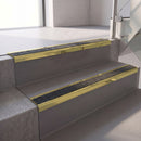 Square edge with ramped back aluminium stair nosing, 70mm tread, obsidian (dark charcoal) Mor Grip insert, mirrorflect gold finish