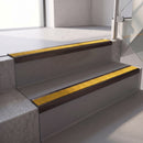 Square edge with ramped back aluminium stair nosing, 70mm tread, solar (golden yellow) Mor Grip insert, dark bronze finish