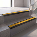 Square edge with ramped back aluminium stair nosing, 70mm tread, solar (golden yellow) Mor Grip insert, satin black finish