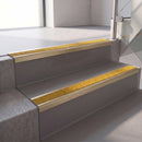 Square edge with ramped back aluminium stair nosing, 70mm tread, solar (golden yellow) Mor Grip insert, satin gold finish