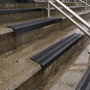Square edge with ramped back aluminium stair nosing with black gritted exterior grip insert in satin black finish fitted on covered external concrete steps