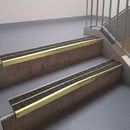 Square edge with ramped back aluminium stair nosing, 93mm tread, obsidian (dark charcoal) Mor Grip insert, satin gold finish