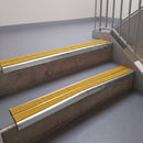 Square edge with ramped back aluminium stair nosing, 93mm tread, solar (golden yellow) Mor Grip insert, bright polished finish