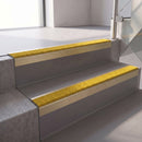 Square edge with ramped back aluminium stair nosing, 70mm tread, brimstone (safety yellow) exterior grip insert, satin gold finish