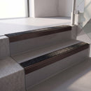 Square edge with ramped back aluminium stair nosing, 70mm tread, coal (black) exterior grip insert, dark bronze finish