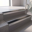 Square edge with ramped back aluminium stair nosing, 70mm tread, coal (black) exterior grip insert, mill finish finish